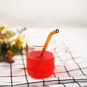 Eco-friendly heat-resistant bent glass straw in a clear glass cup with red liquid