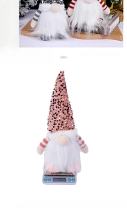 Christmas gnome doll with pink sequins and long white beard weighed at 82g on a digital scale
