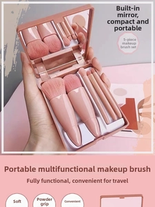Detail showing portable 5-piece pink makeup brush set with built-in mirror in handheld case