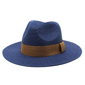 Detailed weave pattern of a navy blue straw panama hat with a brown decorative band