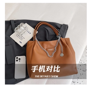 Detail showing spacious interior and premium pebbled texture of this brown tote bag