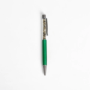 Elegant green metallic ballpoint pen featuring clear barrel filled with natural crystals