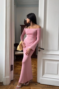 Detailed close-up of pink off-shoulder knit top and high-waisted skirt texture