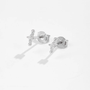 Detail shot of S925 sterling silver cross studs featuring sparkling cubic zirconia