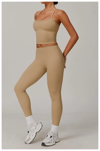 Detail of camel sports vest with slim straps and high-waist stretch yoga leggings