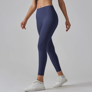 Close-up of ergonomic side stitching on dark blue high-waisted yoga leggings
