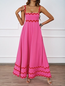 Detail showing the red scalloped trim on a bright pink maxi summer vacation dress