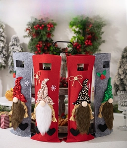 Detail of Christmas gnome wine bottle covers in red and grey felt with sequined hats
