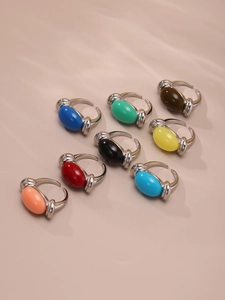 Macro shot of silver rings with colorful oval resin gemstones in multiple candy colors