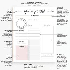 Macro detail of the white 8.5x11 daily planner showing time slots and health tracking