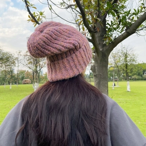 Detailed close-up showing thick ribbed texture of the pink mixed knit beanie hat