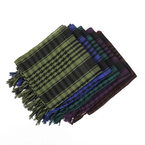 Close-up of stacked houndstooth tactical scarves featuring fringe details in multiple colors