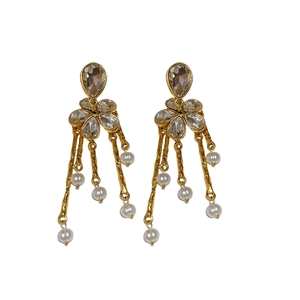 Boucles d'oreilles fleurs vintage avec pierres en goutte et perles sur fond blanc