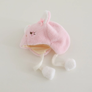 Detail of pink baby winter hat with cute plush cat ears and soft faux fur pom-poms