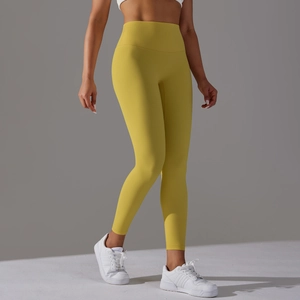 Detailed side view of high-waisted ginger yellow yoga pants with seamless peach lift design