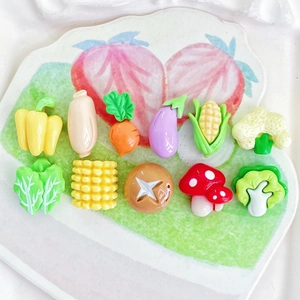 Collection of 11 miniature resin vegetable charms including corn, carrot and eggplant