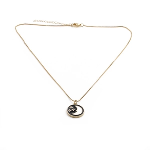 Minimalist gold plated copper necklace with black enamel crescent moon and star pendant