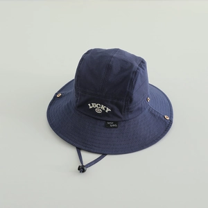 Detailed view of navy blue boys bucket hat with LUCKY embroidery and adjustable chin strap