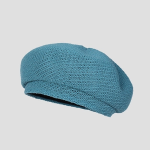 Detail of light blue knitted beret showing breathable hollow knit texture and fine stitching
