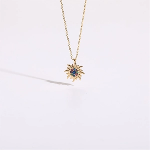 Macro shot of 14K gold-plated sunburst pendant featuring vibrant multi-colored zircon stones