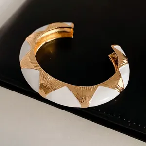 French vintage white enamel and gold-plated open bangle featuring brushed metal texture
