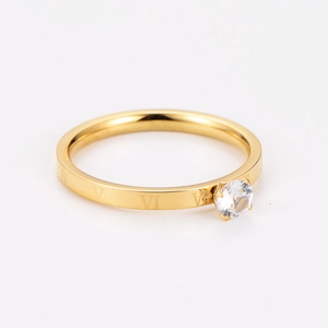 Detailed macro view of gold ring featuring Roman numerals and a sparkling zircon inlay