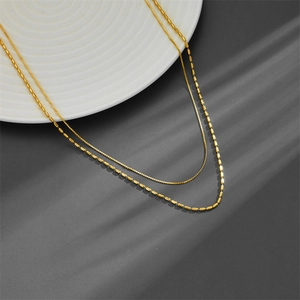 Elegant 18K gold-plated double-layer necklace with wheat ear beads on dark background