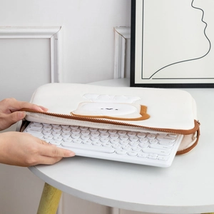 Close-up of fluffy cream iPad sleeve with cute bread embroidery and zipper closure