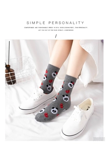 Detail of gray cotton crew socks featuring cute cartoon panda and strawberry patterns