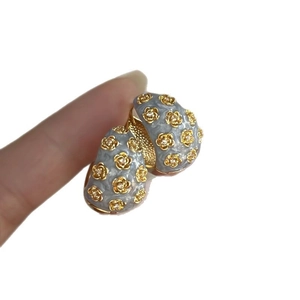 Vintage C-shaped floral hoop earrings in blue enamel with gold accents for a retro look