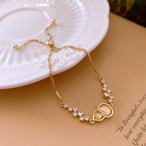 Detailed close-up of golden zircon gourd bracelet with adjustable box chain and slider