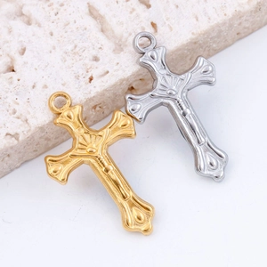 Vintage multilayer cross pendant in gold and silver steel on a white stone background