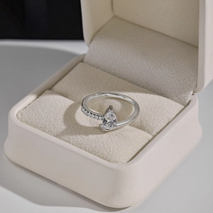 Close-up of S925 sterling silver ring featuring a large pear-shaped zircon and engraving