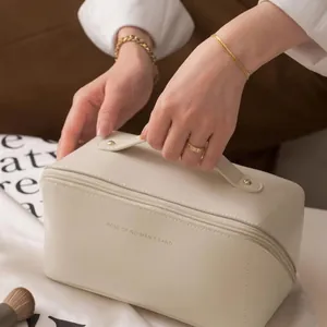 Creamy white PU leather makeup bag with double zipper and top handle for travel