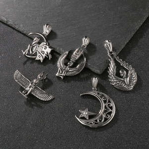 Detailed view of silver ancient Egyptian wings and celestial pendants on rock texture