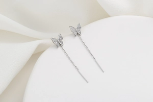 Detailed macro view of butterfly threader earrings with sparkling cubic zirconia stones