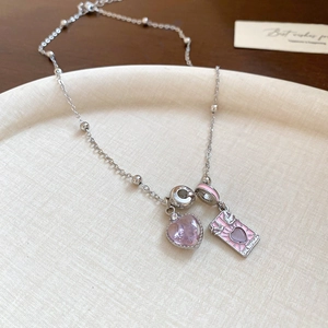 Detailed macro view of S925 silver necklace with pink heart crystal and enamel pendant