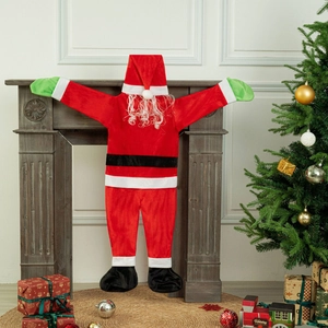 Velvet Santa Claus climbing wall decoration hanging on a fireplace mantel