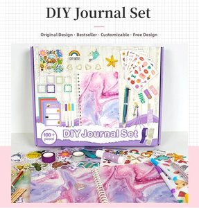 Detail of purple DIY journal set featuring glitter notebook and cartoon stickers