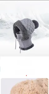 Detail of soft grey faux fur lining and knit texture on thermal winter hat and neck warmer