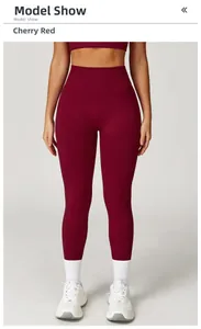 Detail view of high-waist yoga pants in cherry red with seamless ribbed waistband