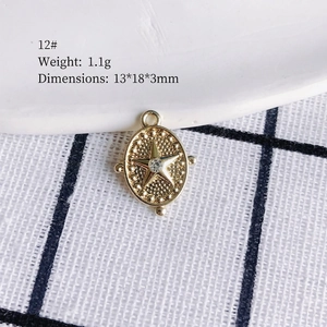 Macro view of a gold alloy oval star pendant with crystal inlay, size 13x18x3mm