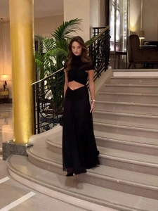 Elegant two-piece black mesh evening gown with halter neck and floor-length skirt