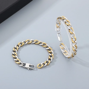 Detailed macro of two-tone gold and silver 9mm stainless steel Cuban link bracelets
