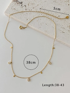 Macro view of gold tassel necklace chain detailing 38cm to 43cm adjustable length
