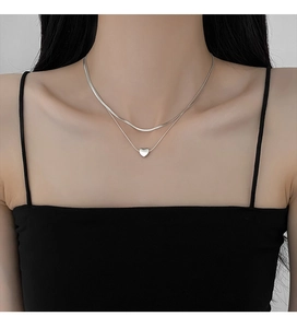 Silver double-layer necklace featuring a flat snake chain and a delicate heart pendant
