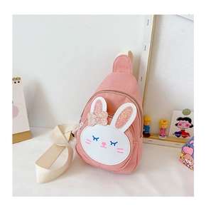Pink canvas kids chest bag with sequined rabbit character on a minimalist white desk
