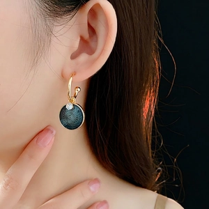 Vintage gold hoop earrings with dark green enamel floral charms and zircon details