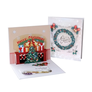 3D pop-up Christmas card featuring a festive fireplace and tree on a white background