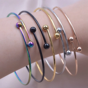 Adjustable titanium steel open bangles in five colors worn on a female wrist
